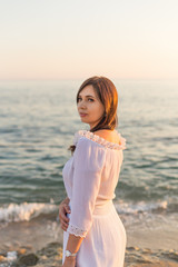 Portrait of a beautiful young woman by seaside