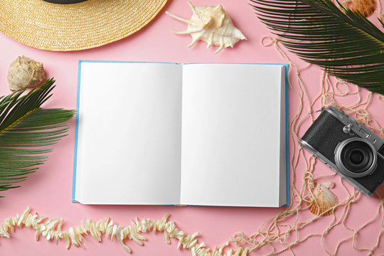 Flat lay composition with open book on pink background