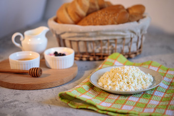 Tasty and healthy breakfast, natural cottage cheese, fresh croissant with honey. Morning still life. Bakery products.