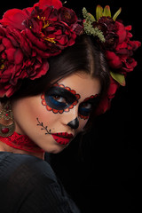 White sugar skull Dia De Los Muertos  on poster for Halloween party with creative make-up or holiday on dark background with copyspace. Beautiful Model, close up in studio. 