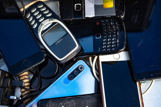 Close up on pile of  broken cell phones in an electonic waste collection centre