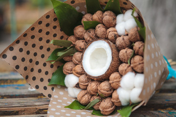 A bouquet of walnuts and coconut with natural cotton flowers. Edible bouquet. Close-up