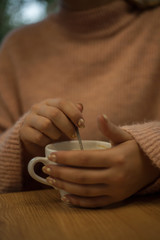 hands holding cup of coffee