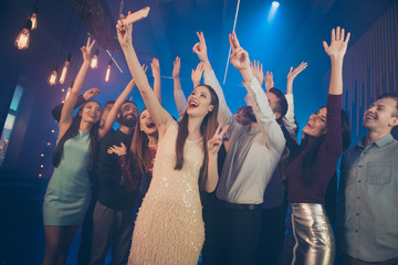 Good mood best meeting concert city life concept. Photo of nice glad positive raising hands up buddies taking selfie on cell in luxurious neon place saying hello to blogger subscribers