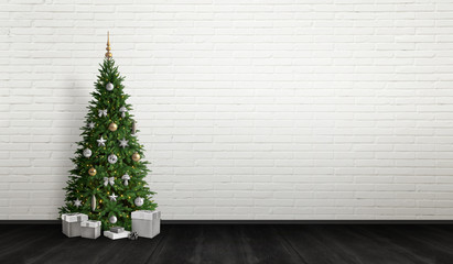 Decorated Christmas tree with gifts below. Free space for greeting text on white brick wall