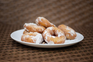 donuts on a plate in powdered sugar