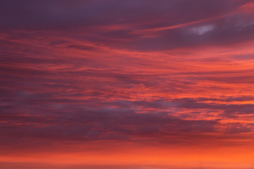 Dramatic epic sunset orange pink sky with clouds background texture
