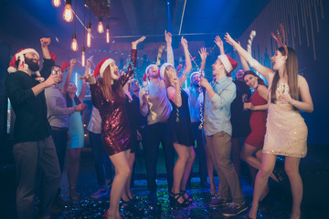 Full body photo of party people raising hands up overjoyed x-mas night best friends on dance floor...