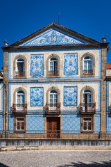 Traditional Portuguese house covered with typical colorful tiles or azulejos.