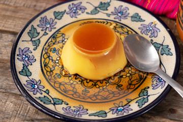 Vanilla flan dessert on wooden background