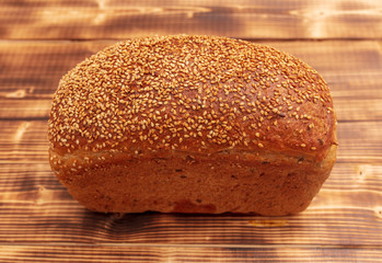 Fresh wheat bread on a wooden background