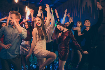 Portrait of cheerful group of people mates dancing in nightclub have fun on noel discotheque wear...