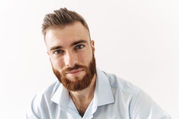 Image of happy handsome bearded man in shirt looking at camera