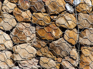 Stones in a metal grid as an abstract background