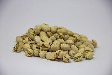 slide of pistachios on a white background. isolate