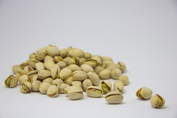 slide of pistachios on a white background. isolate