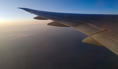 Dawn of the sun in the window of an airplane