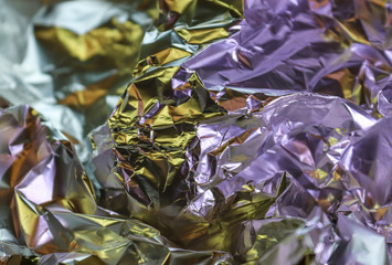 Detailed close up texture of an aluminum foil surface in different colors