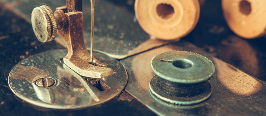 Old retro sewing machine and details of needle close-up of thread, bobbin