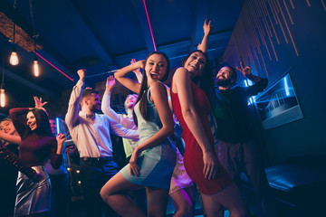 Lets party. Low angle view photo of cheerful wild crowd people dance on disco floor celebrate high-school graduation feel rejoice raise hands wearing formalwear dress