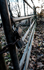 Multiple padlocked, locked gate seen at the entrance to a farm. Part of increased security due to farm machinery thefts.