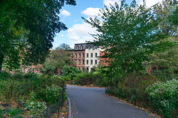 Naklejka premium Empty Path at Fort Greene Park in Brooklyn New York with Homes in the Background