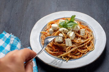 Spaghetti pasta with fresh and parmesan cheese on dark background