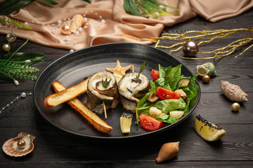 Baked seabass with eggplant, mozzarella cheese, with fresh salad and grissini sticks