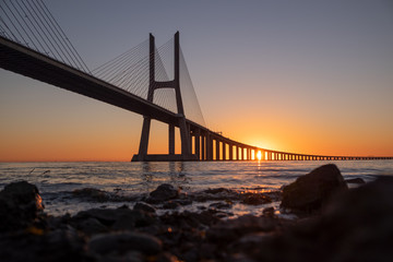 Vasco da Gama Bridge at sunrise in Lisbon, Portugal. Second longest bridge in Europe.