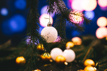 Toys to decorate the Christmas tree on a bokeh background with multi colors.