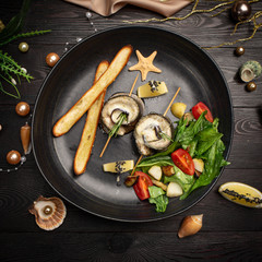 Baked seabass with eggplant, mozzarella cheese, with fresh salad and grissini sticks