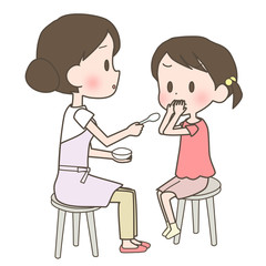 子供に薬を飲ませる母親