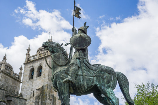 Statue of Vimara Peres ( the first ruler of the County of Portugal) in front of the Porto Cathedral in Porto city , Portugal .