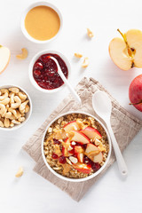 apple peanut butter quinoa bowl with jam and cashew for healthy breakfast