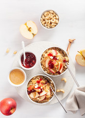 apple peanut butter quinoa bowl with jam and cashew for healthy breakfast