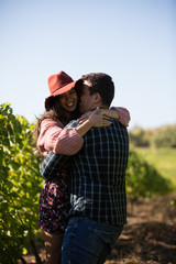 Romantic young man spinning her beautiful girlfriend in vinyard