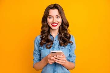 Photo of trendy cheerful cute nice sweet pretty girl smiling toothily holding phone with hands...
