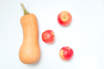 One pumpkin and three apples on a white background. Ingredients for diet salad or freshly squeezed juice.