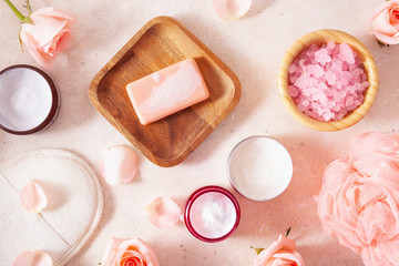 skincare products and rose flowers. natural cosmetics for home spa treatment