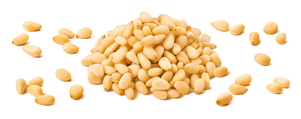 Pine nuts pile and separate kernels isolated on white background