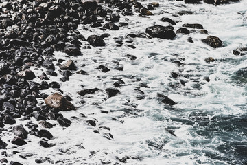 Black beach with wave