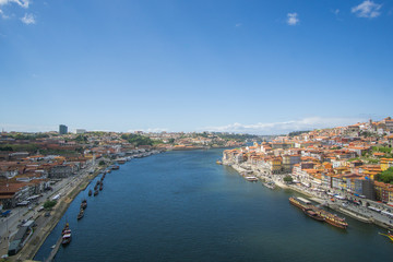 Panoramic view of Porto city , the beautiful buildings and their colorful rooftops from both sides and the douro river below , was captured from the Luís I iconic bridge Bridge