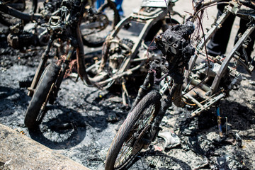 Terrorists set fire to motorbikes on a street in the city.