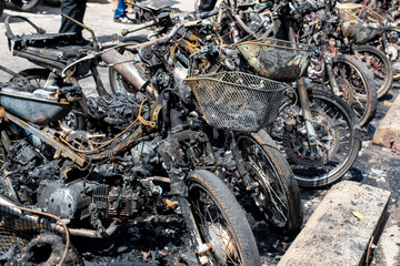 Terrorists set fire to motorbikes on a street in the city.