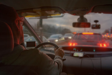 Driving a car in the city at night in traffic jams