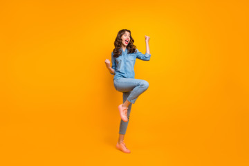 Fototapeta na wymiar Full length body size photo of ecstatic overjoyed crazy cheerful pretty girl overjoyed about new information known shouting making fists expressing emotions isolated vivid color background