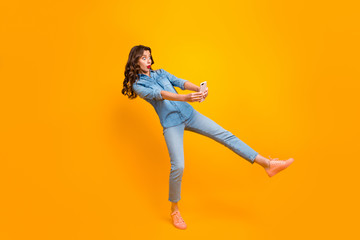 Fototapeta na wymiar Full length body size turned photo of frightened shocked funny girl wearing jeans denim taking selfie having noticed something unexpected isolated over yellow vivid color background