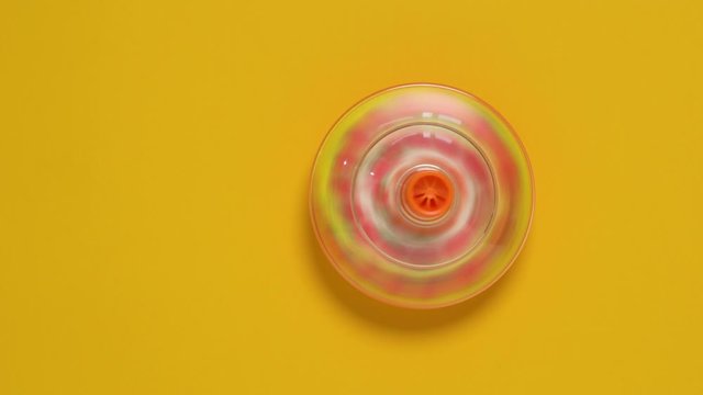 Kids whirligig humming spinner on yellow background