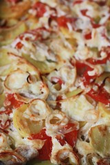 Baked potatoes with chicken and tomatoes close up