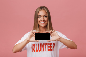 Happy young volunteer girl standing isolated